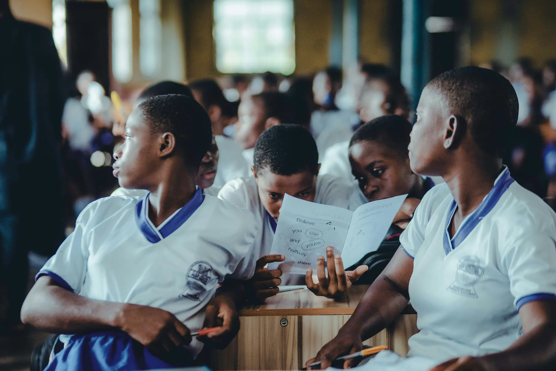 Inspiring shot of Ghanaian students in a classroom, looking hopeful and engaged.