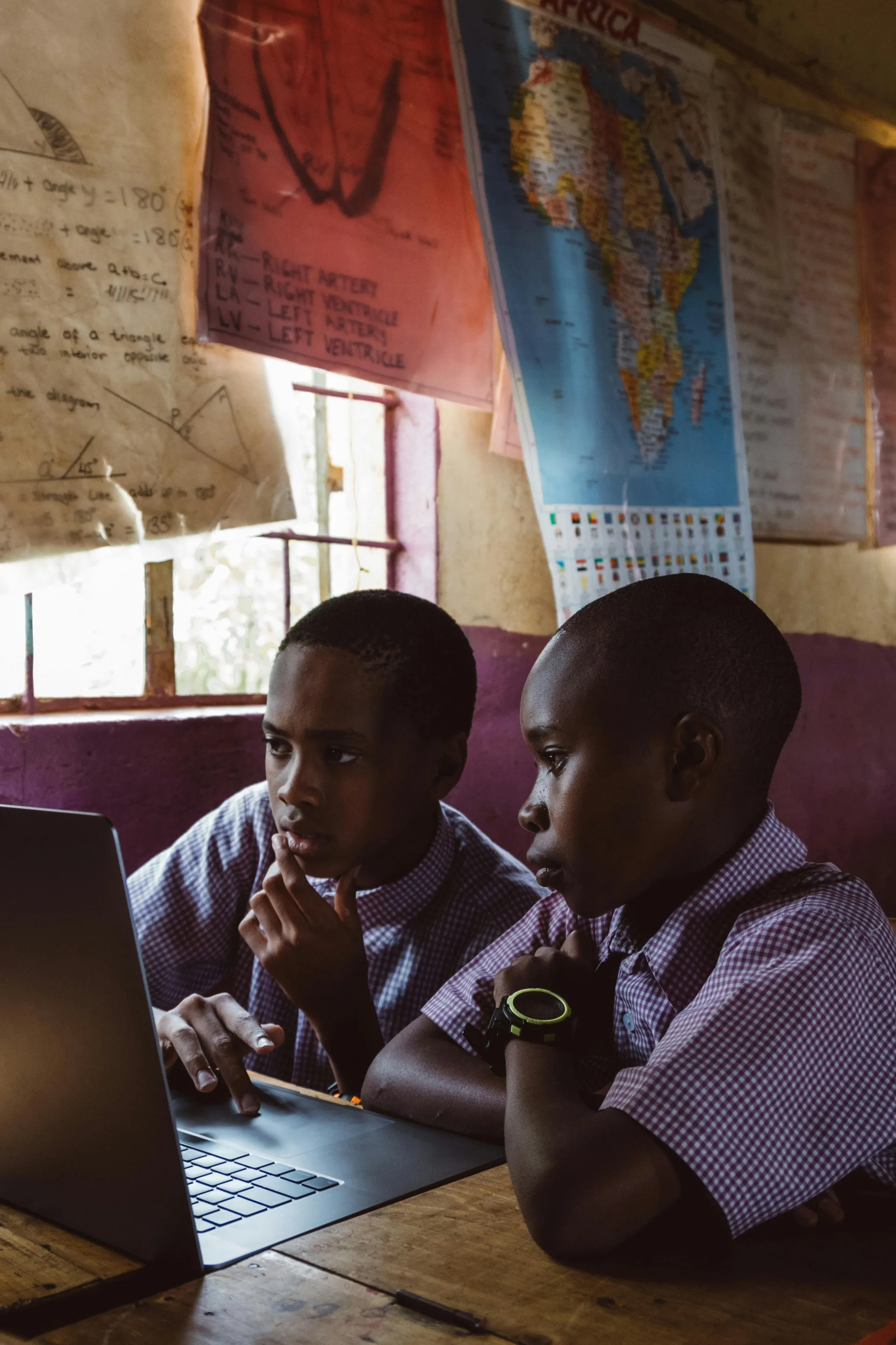 A close-up of a student writing in a notebook, symbolizing the direct impact of donations on learning.